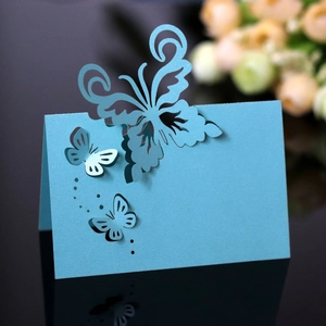 Detail of laser-cut light blue butterfly place card with elegant pearl paper texture