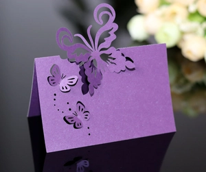 Macro detail of purple laser-cut butterfly place card with elegant folding paper design