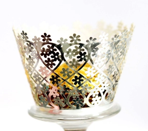 Elegant laser cut silver cupcake wrappers with floral heart patterns for wedding party decor