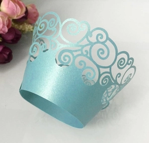 Detailed laser-cut light blue cupcake wrapper with pearlescent finish for weddings