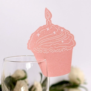 Pink cupcake shaped paper place cards with laser cut candle design for party glass decor