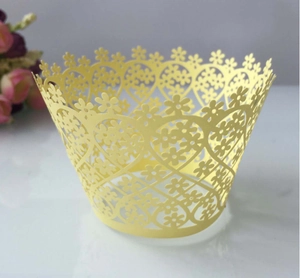Detail showing laser-cut floral and heart lace cupcake wrapper in pale yellow finish