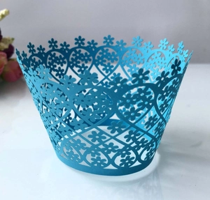 Detail showing blue laser-cut cupcake wrappers with floral heart geometric patterns