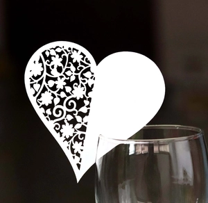 White heart-shaped laser cut wine glass place card with floral hollow design for weddings