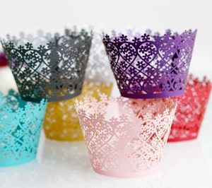 Close-up of laser-cut floral cupcake wrappers in various vibrant pearlescent colors