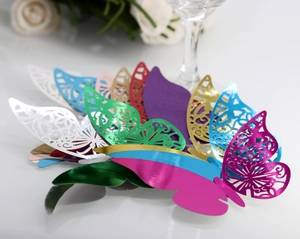 Detailed laser-cut hollow butterfly decorations in assorted pearlescent paper colors