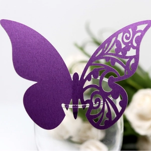 Marque-place papillon violet découpé au laser pour verres à vin lors de mariages