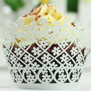White laser cut floral cupcake wrappers for wedding party decoration on red velvet cake