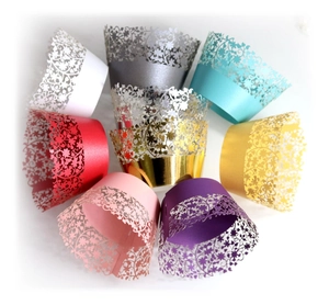 Laser cut floral cupcake wrappers in various metallic colors for wedding party decoration