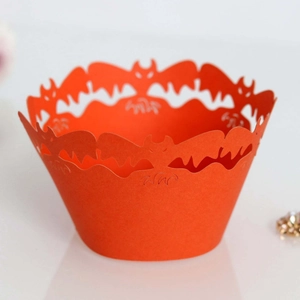 Laser-cut orange cupcake wrapper with hollow bat pattern for Halloween decoration