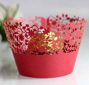 Red laser-cut cupcake wrapper with floral vine patterns for wedding dessert decoration