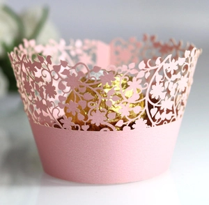 Pink laser-cut floral lace cupcake wrappers made of pearlescent paper for wedding decor
