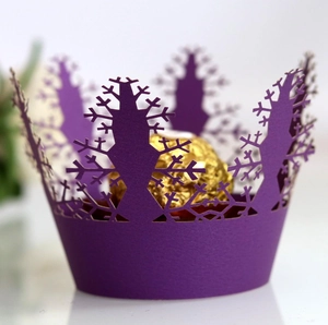Purple laser cut snowflake paper cupcake liner with a gold chocolate inside