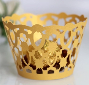 Laser cut golden hollow lace cupcake wrapper with intricate geometric floral design