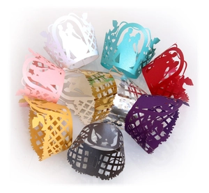 Detailed laser-cut cupcake wrappers in multiple colors for wedding party decoration