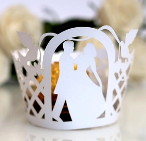 Detailed laser-cut white cupcake wrapper with romantic wedding couple and floral design