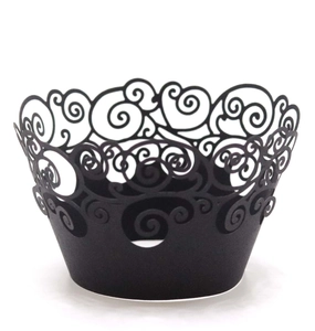 Detailed macro view of black laser cut cupcake wrappers with elegant swirl patterns