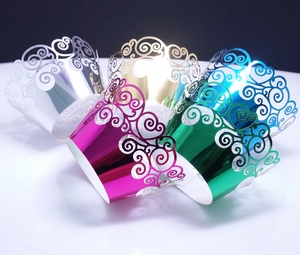 Laser cut cupcake wrappers with metallic scroll patterns in assorted vibrant colors