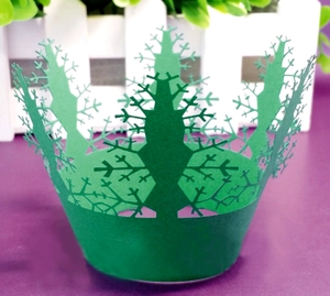 Laser cut green Christmas tree cupcake wrappers with hollow snowflake patterns for parties