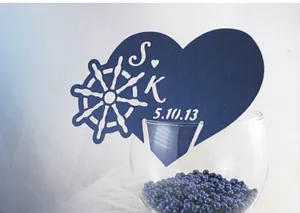 Laser-cut navy blue heart-shaped wine glass escort card with nautical anchor design