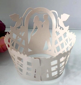 Laser cut lace cupcake wrappers featuring laser cut silhouettes of bride and groom for weddings