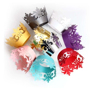Detailed laser-cut crown pattern on colorful metallic cupcake wrappers for decorations