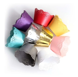 Close-up of laser-cut cupcake wrappers with rose flower patterns in assorted pearl colors