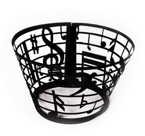 Detailed macro view of laser-cut musical notes and staff on black cupcake wrapper