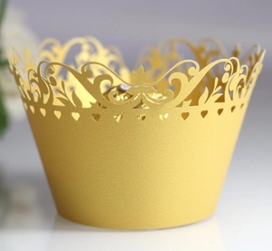 Laser cut hollow crown cupcake wrappers in gold pearlescent paper for wedding decorations