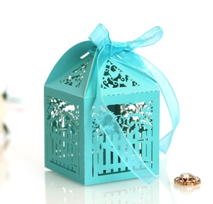 Laser cut blue wedding favor box with fence and bird patterns and ribbon bow
