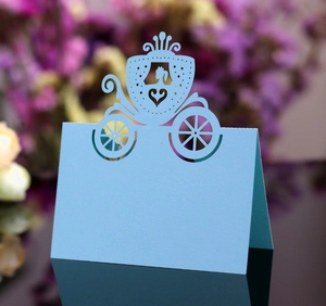 Detailed laser-cut light blue wedding place card featuring a pumpkin carriage and princess