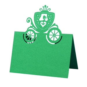 Detailed laser-cut green wedding place card featuring an intricate carriage design