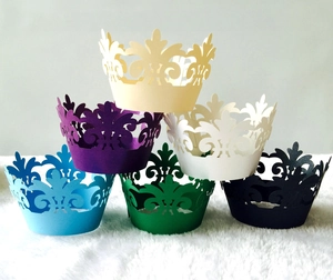 Detailed view of six-color laser-cut cupcake wrappers with elegant crown patterns