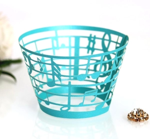 Detailed laser cut cyan cupcake wrapper with musical note pattern and music staff
