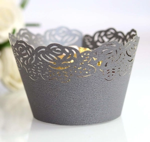 Macro detail of laser-cut rose hollow cupcake wrapper in elegant pearl grey finish