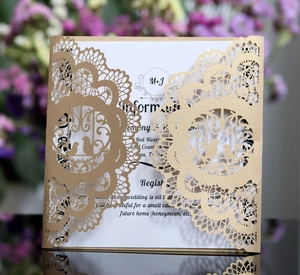 Elegant laser-cut navy blue wedding invitation with gold glitter lace and bird details