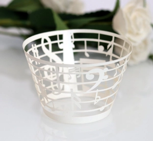 Detailed laser-cut white music note cupcake wrapper for wedding and party decorations