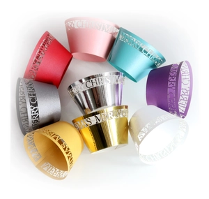 Laser-cut Merry Christmas cupcake wrappers in nine metallic and matte assorted colors