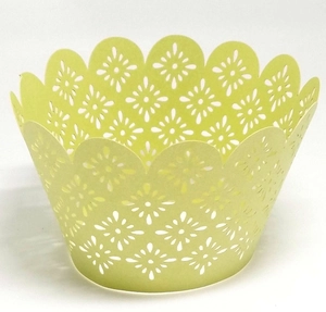 Detailed close-up of laser-cut paper cupcake wrappers featuring yellow floral patterns