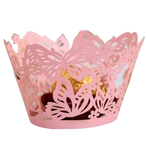 Pink laser-cut cupcake wrapper with butterfly and flower patterns on a white background