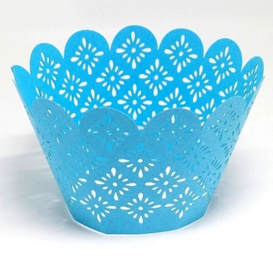 Detailed laser-cut petal pattern on light blue lace cupcake wrapper with scalloped edge