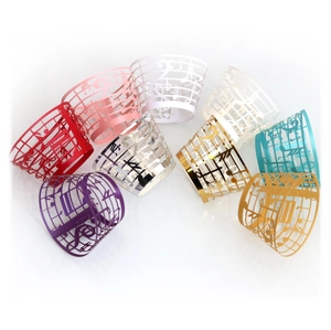 Laser cut music note cupcake wrappers in assorted colors with staff line hollow pattern