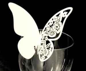 White butterfly paper place card with laser-cut hollow wing design for wine glasses