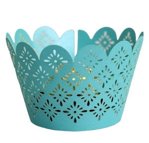 Teal laser-cut cupcake wrappers with floral patterns and scalloped edges for party decor