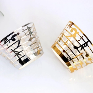 Laser cut music note cupcake liners in gold and silver mirror finish for party decor