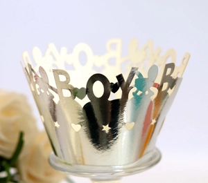 Golden hollow out cupcake wrapper featuring BOY letters and heart stars for baby boy party