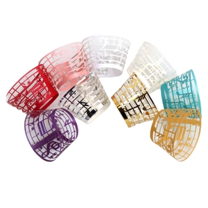 Laser-cut music note cupcake wrappers in various pearlescent colors for party decoration