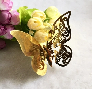 3D laser-cut golden butterfly seat card with intricate floral hollow design