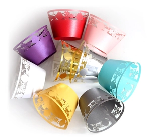 Detailed laser-cut cupcake wrappers with floral teapot patterns in multiple pearlescent colors
