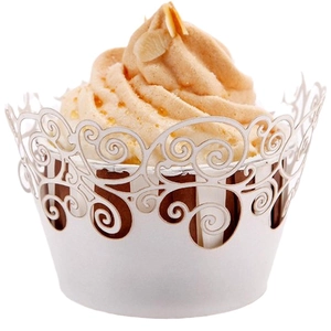 Intricate white laser-cut vine patterns on elegant cupcake paper wrappers for baking